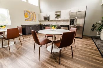 a kitchen and dining room with a table and chairs